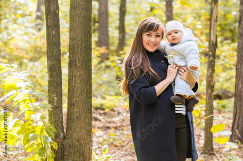 Mother and baby daughter in the autumn park