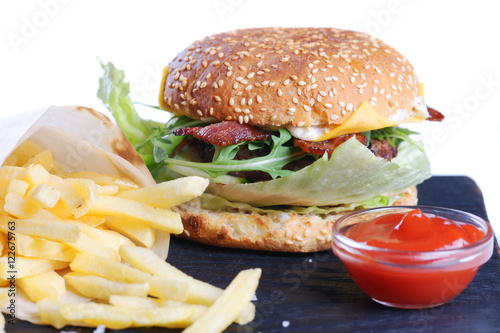 Cheeseburger with fries and ketchup.