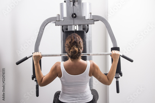  A young woman exercises in a gym