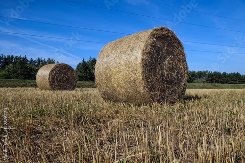 hay rolls on the slanted field 