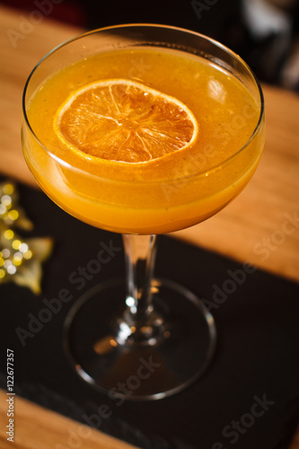Glass of cocktail on bar background
