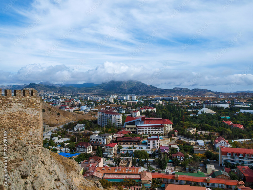 View from the ramparts of the ancient to the modern buildings of the town of Sudak in Crimea