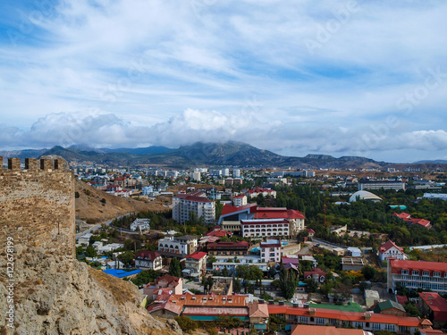 View from the ramparts of the ancient to the modern buildings of the town of Sudak in Crimea © charlyblr