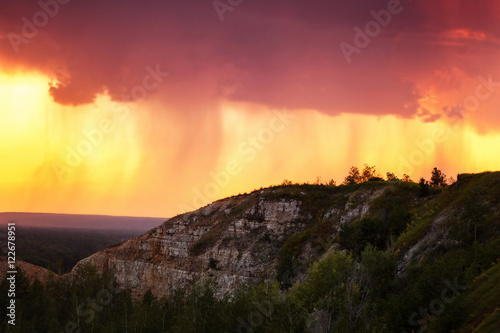 Amazing summer mountain sunset at rainy pink sky background