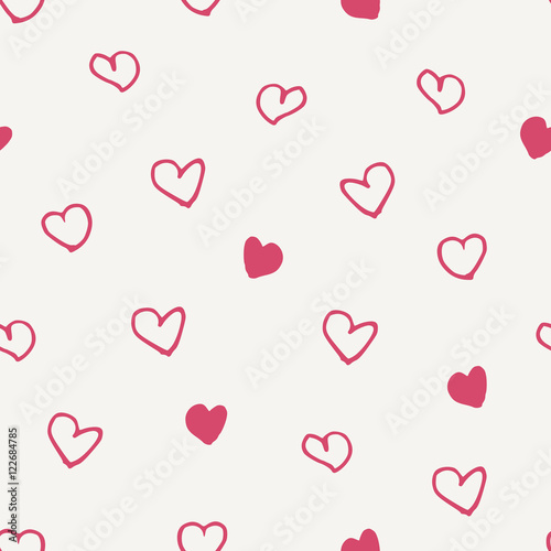 Seamless pattern with hand drawn hearts in pink on cream background.