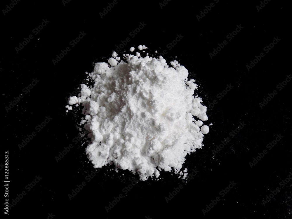 Cocaine drug powder pile on black background Cocaine drug powder pile on black background