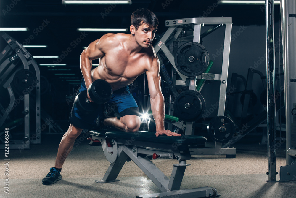 sport, fitness, lifestyle and people concept - flexing muscles with dumbbells in gym sport, fitness, lifestyle and people concept - flexing muscles with dumbbells in gym