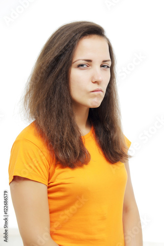 portrait of brunette girl with suspicious emotion. human emotion expression and lifestyle concept. image on a white studio background. mistrusted or offensed, brunette woman