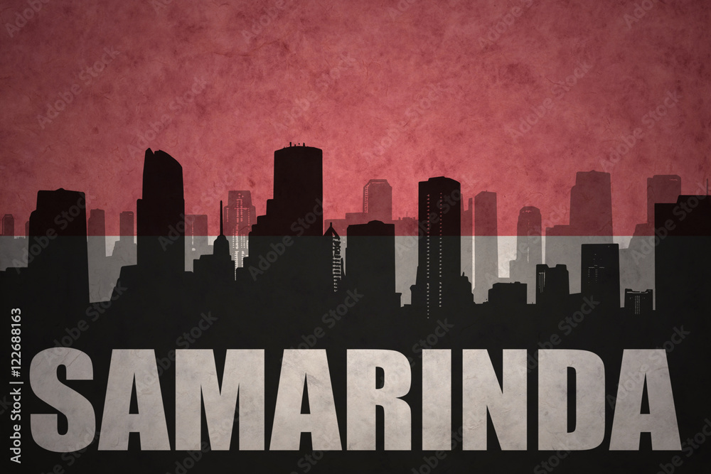 abstract silhouette of the city with text Samarinda at the vintage indonesian flag background