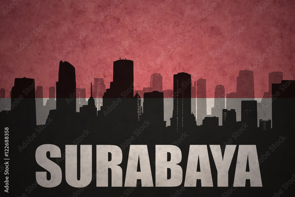 abstract silhouette of the city with text Surabaya at the vintage indonesian flag background