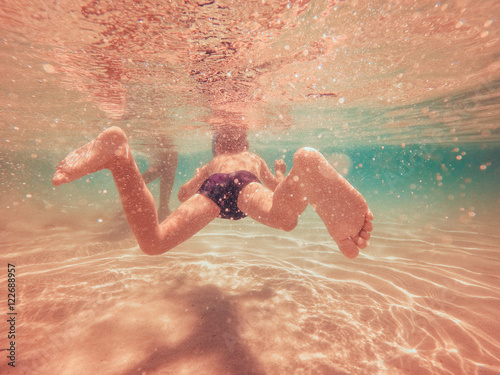  Young boy swimming underwater