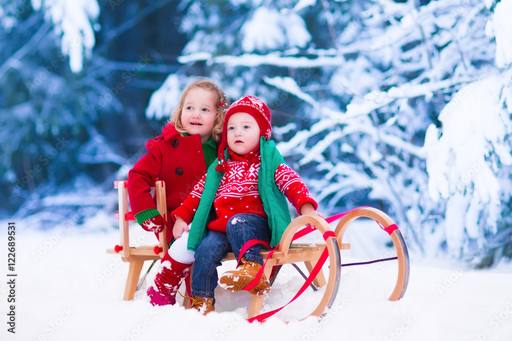 Kids having fun on a sleigh ride in winter