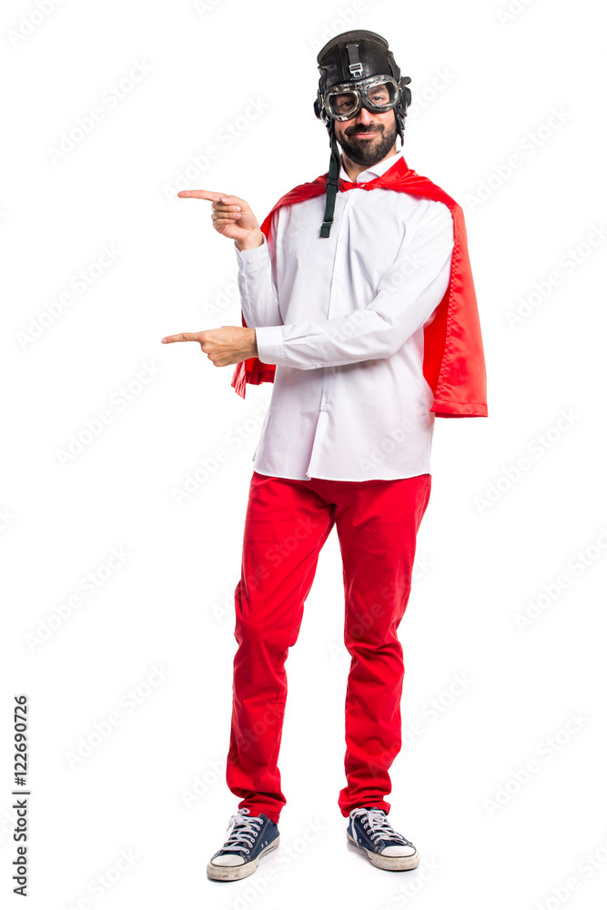 Crazy superhero man pointing to the lateral Crazy superhero man pointing to the lateral