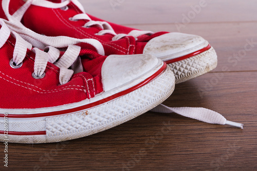 Old canvas shoes on a wooden floor