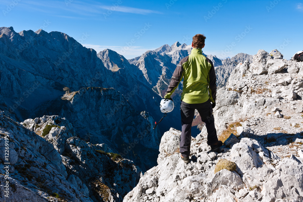 Mountaineer at the top of the Krofička mountain enjoying the view, Slovenia