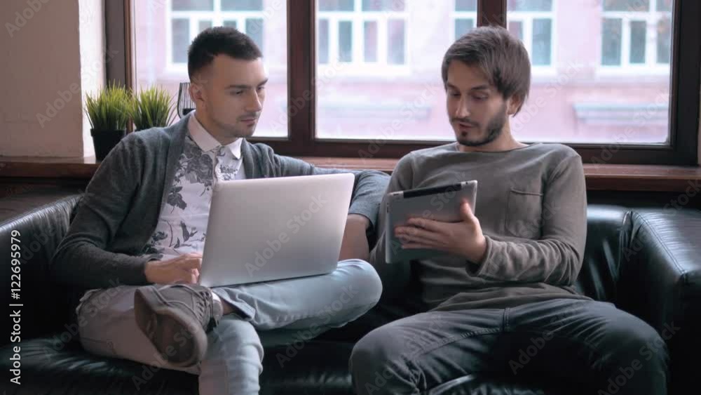 Young freelancers working at the modern office. Businessmans with devices, laptop and tablet in coworking. Young freelancers working at the modern office. Businessmans with devices, laptop and tablet in coworking.