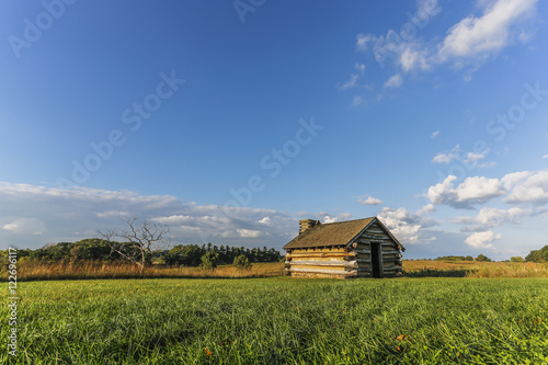 Lone cabin against big sky and landscape