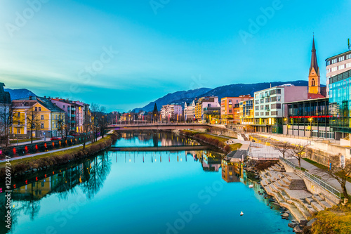 Canvas Print view of a riverside of river Drau during sunset in Villach, Austria