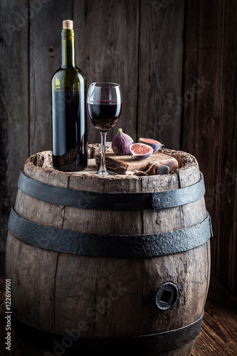 Red wine with figs on old barrel