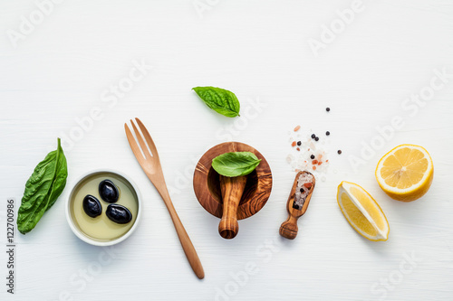 Sweet basil vinaigrette dressing ingredients on white wooden bac photo