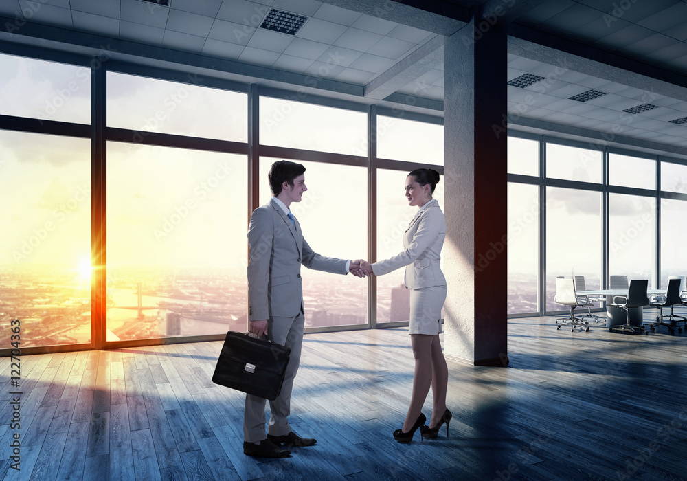 Business partners handshake . Mixed media