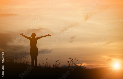 Woman happy at sunset.