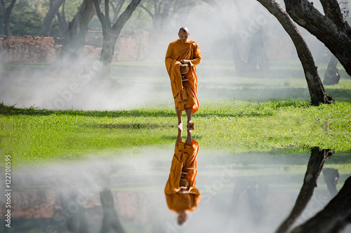 Buddhist monk walk receive food in the morning, among cold weather and fog, Vintage