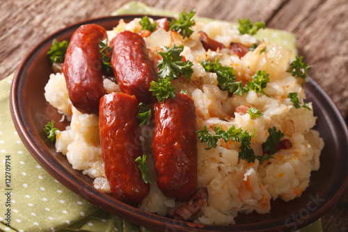 stamppot mashed potatoes, cabbage and carrots, with sausages close-up. Horizontal
