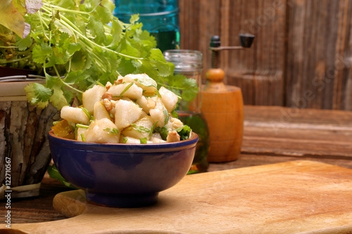 Fototapeta Naklejka Na Ścianę i Meble -  Pear salad with coriander and nuts and place a text