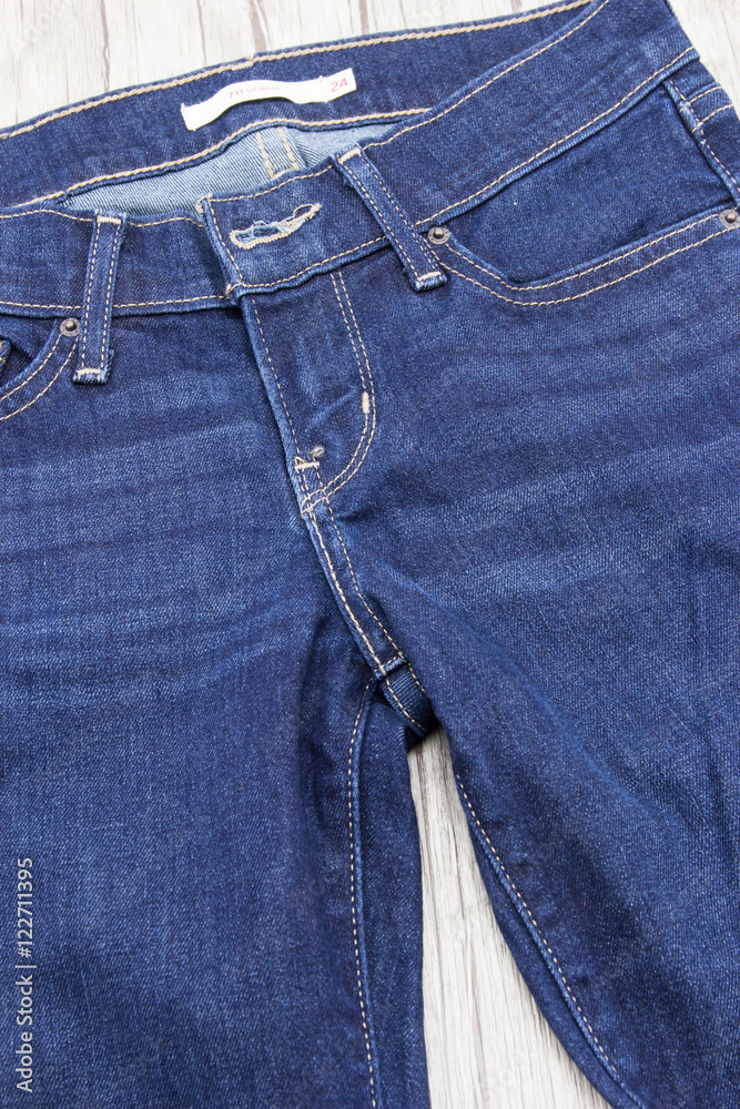 Blue jeans on wooden background. Blue jeans on wooden background.