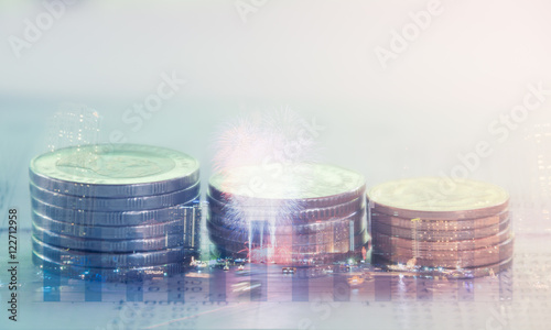 Double exposure of city and rows of coins on bank statement with graph,finance and banking concept