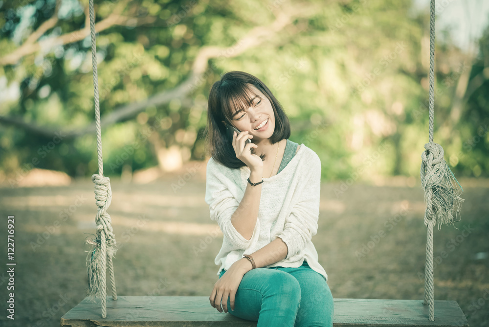 Phone woman in talking in smart phone in park Phone woman in talking in smart phone in park
