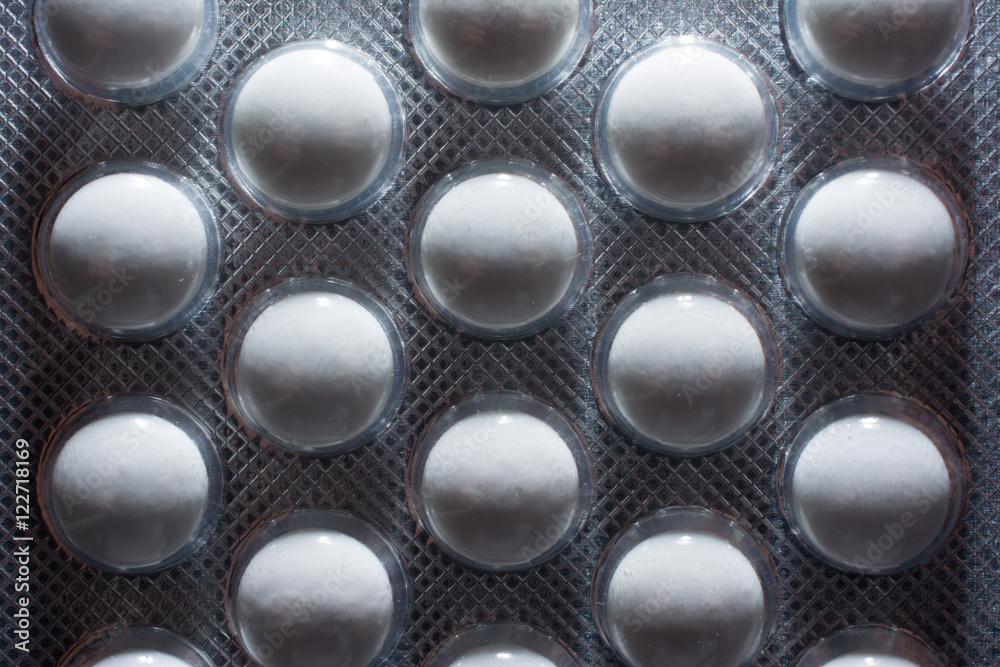 Background in abstract shape, macro photography. Pills packed in