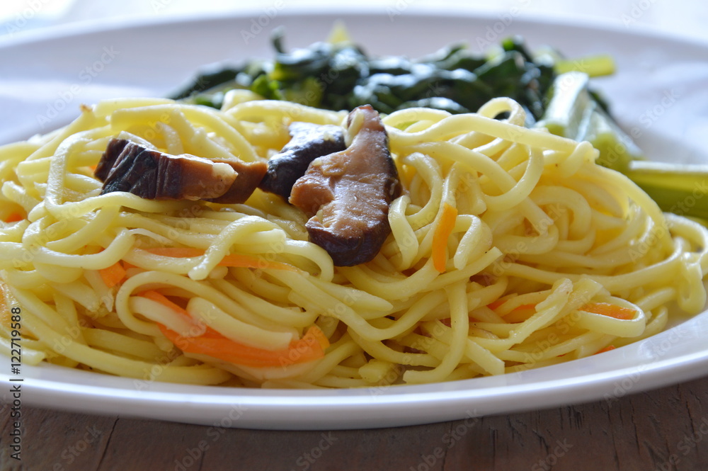 stir fried vegetarian noodle with mushroom and Chinese cabbage on plate stir fried vegetarian noodle with mushroom and Chinese cabbage on plate