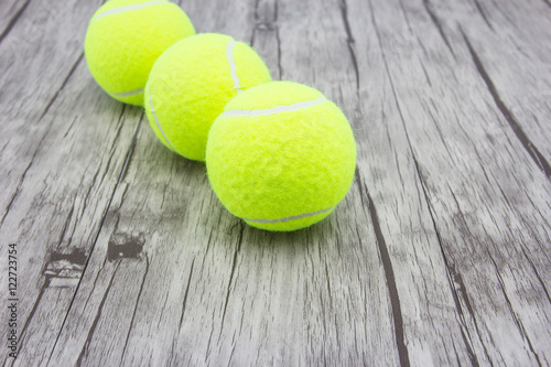 Tennis ball on wood floor © torsak