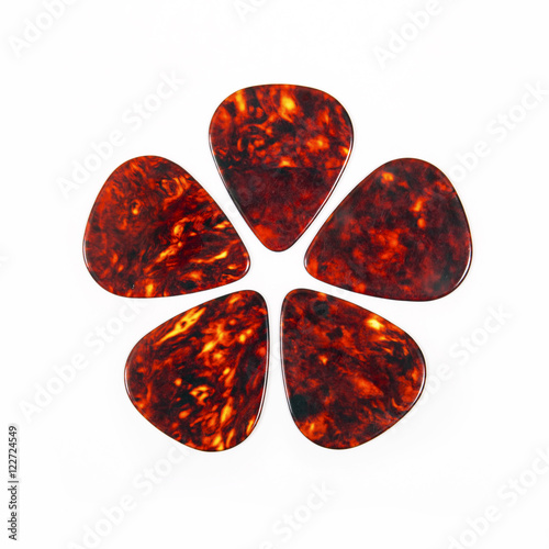 Red guitar plectrums isolated on a white background