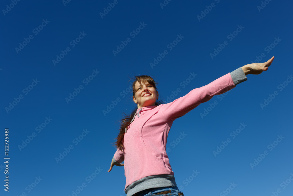 Beautiful young woman against the blue sky. Beautiful young woman against the blue sky.