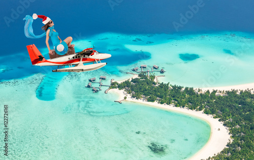 Fototapeta Naklejka Na Ścianę i Meble -  Christmas vacation travel concept with flying girl