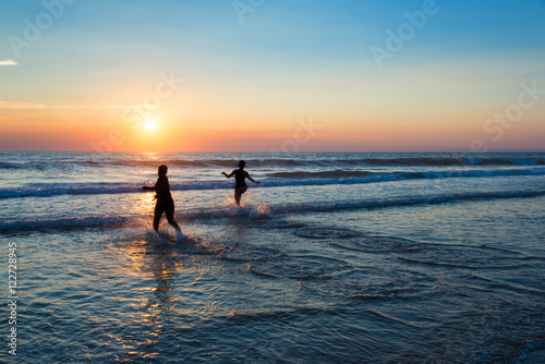 Silhouettes of people enjoying the sunset on the atlantic ocean, Lacanau France © Delphotostock