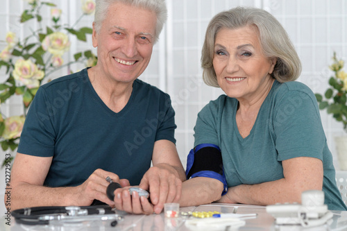 portrait of senior couple with pills