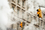 Hanging traffic lights in New York surrounded by steam from the subway