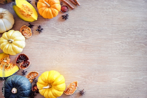 Frame of fresh colorful pumpkins on the wooden table. Top view. Flat lay.