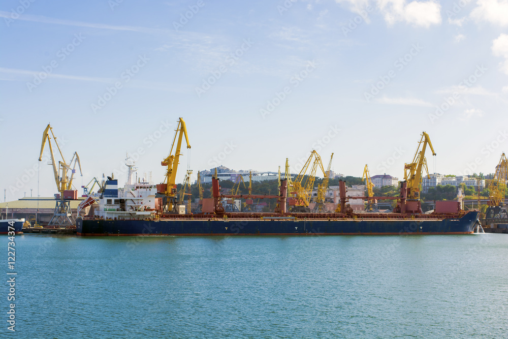 Panorama of the port cranes ships. bulk carrier ship in the port on loading. Panorama of the port cranes ships. bulk carrier ship in the port on loading.