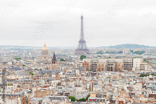 Paris city roofs skyline with Eiffel Tower from above, France