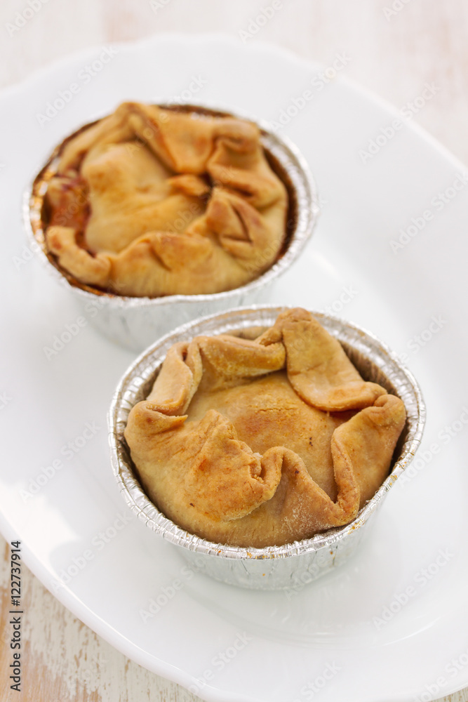 portuguese chicken cookies on white dish on wooden background portuguese chicken cookies on white dish on wooden background