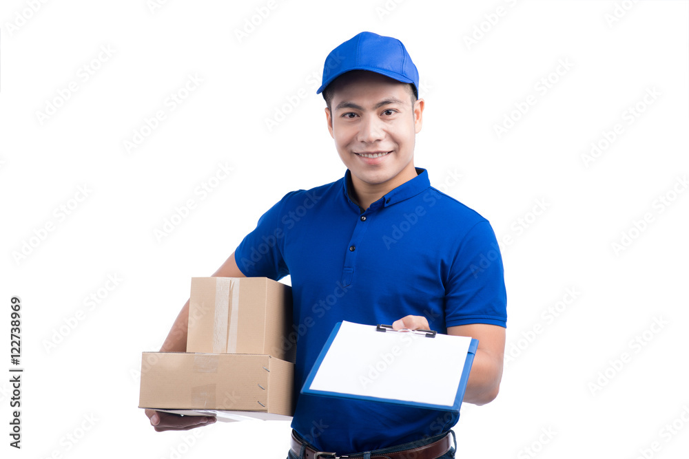 Smiling young asian salesman with parcel and clipboard against a Smiling young asian salesman with parcel and clipboard against a