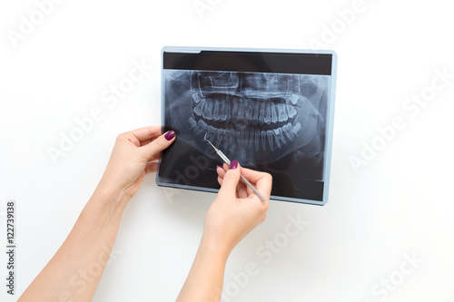 Female doctor dentist looking at x-ray