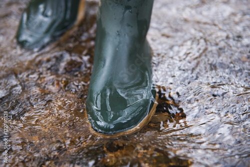 close up on rubber boots in the water