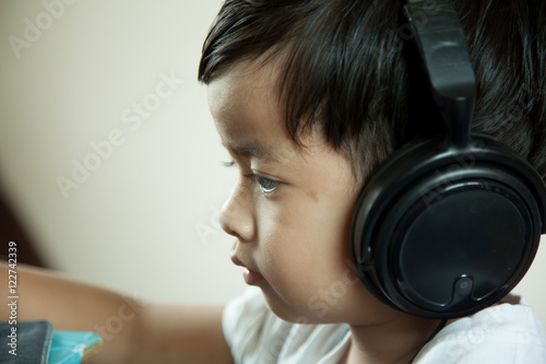 boy and gray background with headphones