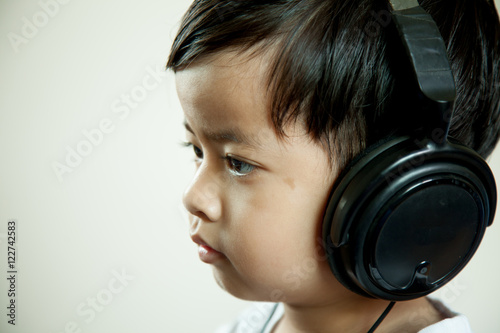 boy and gray background with headphones